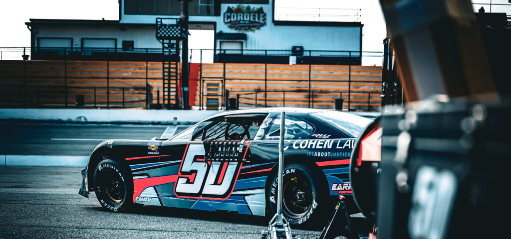 Race car driver Jett Noland’s #50 late model stock car parked at Cordele Motor Speedway, featuring Cohen Law Group sponsorship.