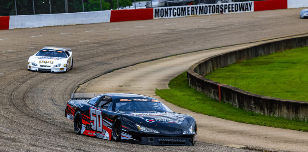 Jett Noland #50 leads the pack at Montgomery Motor Speedway in a black and red late model race car during a high-speed turn on the track.