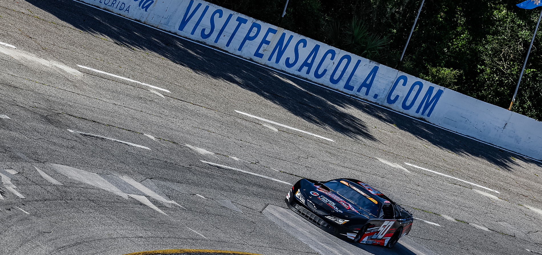 Jett Noland #50 racing at high speed on Pensacola track during a late model race event
